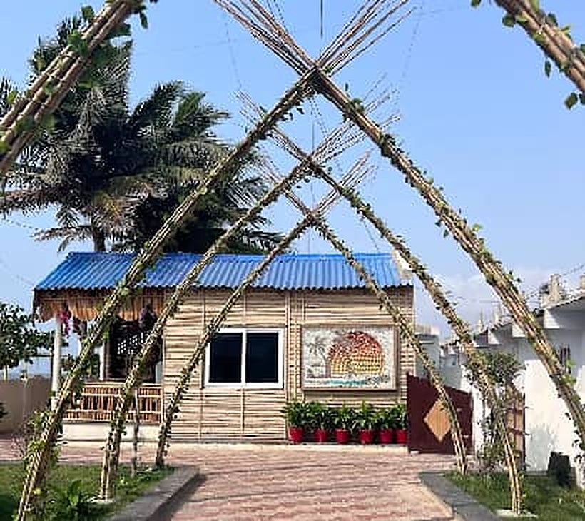 Bamboo cottage framed by a bamboo arch