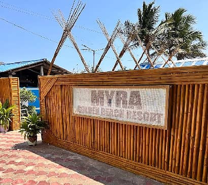 Bamboo wall carrying the Myra Golden Beach Resort sign